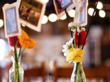 colorful floral centerpieces with the couple’s photos are great for a rustic rehearsal
