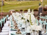a rustic tablescape done in mint and burlap, with white blooms and candles