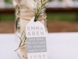a jar with a napkin and cutlery plus a tag and some greenery for a rustic rehearsal