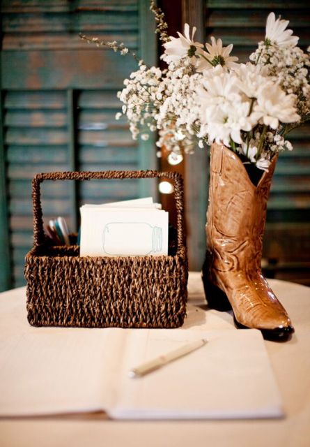 a basket with wishes and a cowboy boot with white blooms for a centerpiece