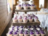 a reclaimed wood tiered sweets stand for both cupcakes and a wedding cake is a great solution for a rustic wedding
