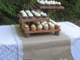 a wooden dessert stand of wooden planks and tree branches is a lovely idea for a rustic or a woodland wedding