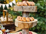 a rustic woodland wedding dessert stand of wood slices and a tree branch can be used for serving fruits and berries, too, and it looks very natural