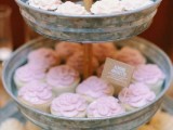 a galvanized metal tiered wedding sweets stand with sweets and cupcakes is a lovely idea for a rustic wedding