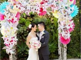 a fantastic wedding arch done with lots of colorful origami decor in various colors is a gorgeous idea for a colorful wedding
