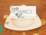 a black and white seating card with origami crane prints is a great idea for a modern wedding with a restraint color scheme