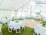 a neutral wedding reception space with colorful origami crane garlands over each table that are a lovely idea that you can DIY