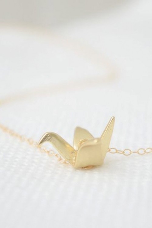 a gold necklace with an origami crane pendant is a lovely idea for wearing at a wedding or to give as a bridesmaid favor
