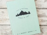 a green wedding guest book with mountains printed will remind your of the place where you tied the knot