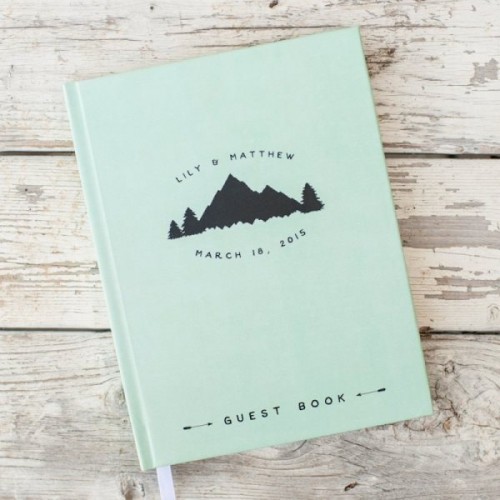 a green wedding guest book with mountains printed will remind your of the place where you tied the knot