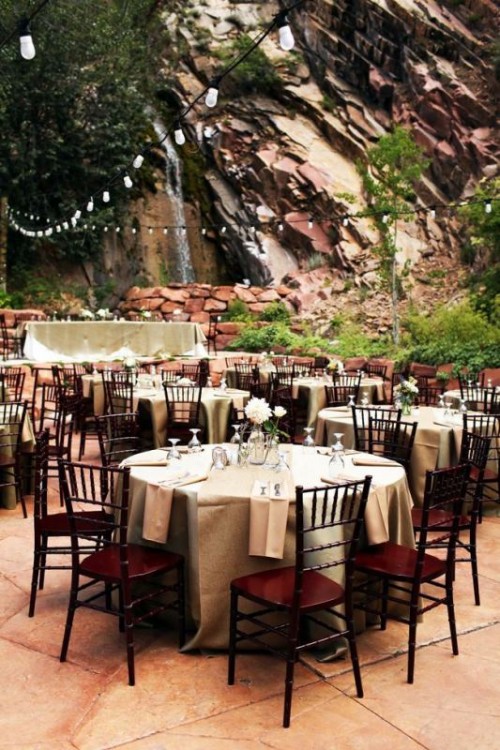 a stylish reception space right in the mountains, with a waterfall and lights over them