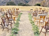 a natural and simple mountain ceremony space done with wooden chairs, greenery runners and a gorgeous mountain view