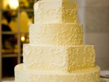 a yellow patterned wedding cake with sugar beads is a traditional and elegant wedding dessert