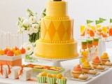 a bold yellow wedding cake with beads and rhombs and a traditional cake topper for a retro-inspired wedding