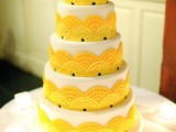 a bright and fun wedding cake in white, with yellow ruffle fans is a cool idea for a bright summer wedding