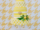 a bright and cool yellow and white wedding cake with striped tiers and tiers that imitate pie covers, lemons and greenery is all fun