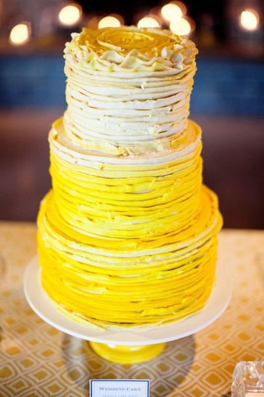 A bold ombre textural ruffled wedding cake from neutrals to deep yellows is a traditional and bold idea for a spring or summer wedding