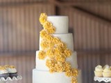 a white lace wedding cake with yellow sugar blooms is a pretty rustic wedding dessert idea