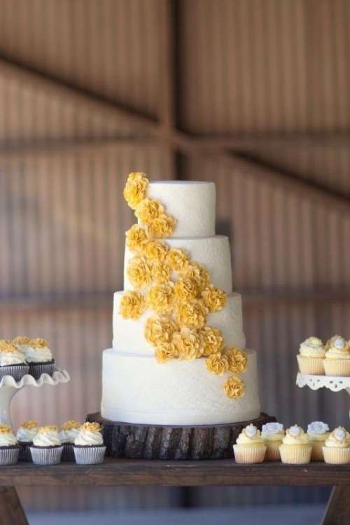 a white lace wedding cake with yellow sugar blooms is a pretty rustic wedding dessert idea