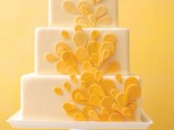 a white square wedding cake with yellow sugar petals is a pretty idea of a wedding dessert with a summer feel