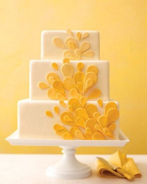 a white square wedding cake with yellow sugar petals is a pretty idea of a wedding dessert with a summer feel