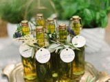 olive oil in bottles with olive foliage and tags on them are a nice wedding favor idea is a very cool and simple idea to rock