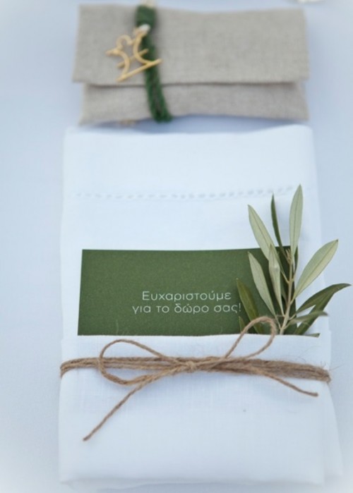 a napkin with a card, some twine and olive greenery is a cool idea to spruce up a usual and neutral place setting