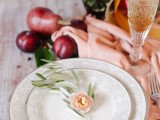 mark each place setting with olive greenery and a blush bloom for a tender touch at a spring or summer wedding