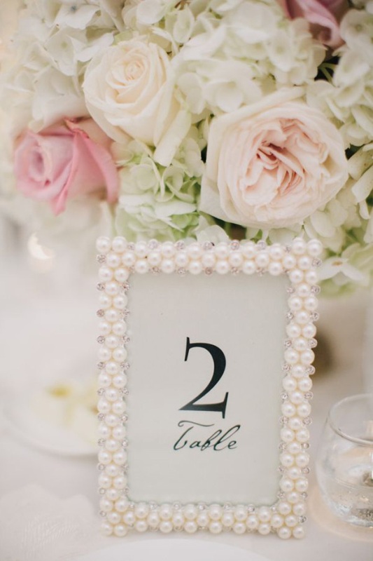 A chic and glam wedding table number in a pearl frame is a cool idea to accent your table