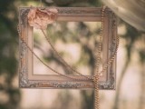 a refined frame with a pink flower and strands of pearls to make chic vintage-inspired photos