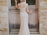 a lace applique A-line wedding dress with an open back and lots of strands of pearls to look wow