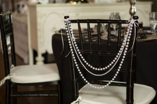 the back of the chair highlighted with strands of pearls looks chic, refined and elegant