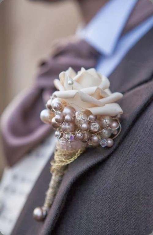 a whimsical wedding boutonniere of pearls, beads, a faux rose is a quirky and glam idea