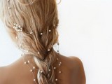 a loose braid with a pearly hair vine that gives a glam and chic touch to the hairstyle – perfect for many bridal styles