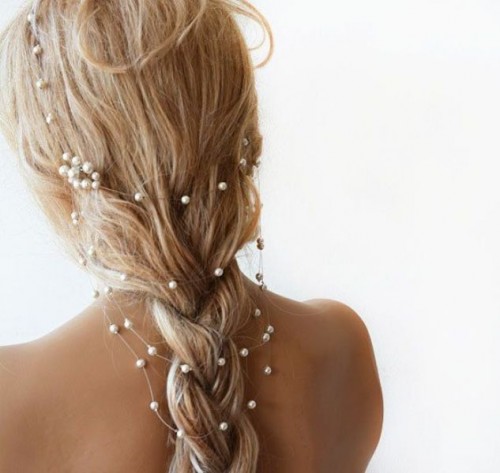 a loose braid with a pearly hair vine that gives a glam and chic touch to the hairstyle - perfect for many bridal styles