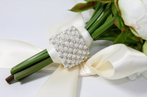 a glam rhinestone and pearl bouquet wrap and a large silk bow to accent the wedding bouquet