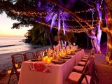 string lights paired with candle lanterns on the tables are a great solution for a beach wedding reception