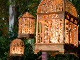 pendant cages filled with LED lights are a creative solution for a secret garden or fairy tale wedding