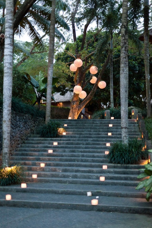 Candle lanterns and paper pendant lamps are a great combo for a destination wedding, and they won't break the budget