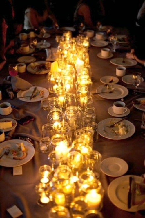 a table runner composed of jars with candles is a great way to add coziness to the tablescape and illuminate it a little bit