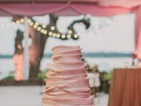 a blush ruffle wedding cake is a beautiful and stylish idea to rock for a modern wedding, perhaps with a rustic feel