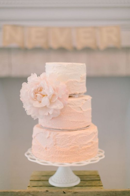 a textural pink wedding cake with an oversized bloom is a beautiful idea for a spring or summer wedding