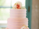 a pink textural buttercream wedding cake with white and pink blooms on top is a pretty and lovely idea for a spring or summer rustic wedding