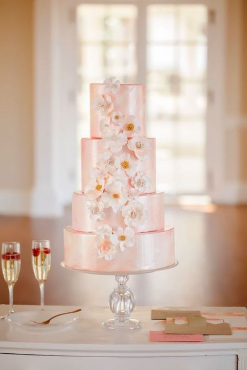 a shiny pink multi-tier wedding cake with white sugar and usual blooms is a fantastic idea for a spring or summer wedding in a delicate shade