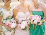 mismatched bridesmaid dresses – a blush strapless one, an emerald strapless one and a floral dress with short sleeves