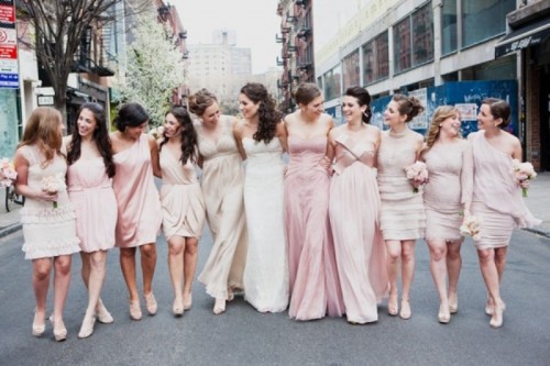 mismatched blush and neutral bridesmaid dresses of knee length are nice and chic for a neutral wedding