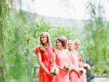 mismatched bright pink and red bridesmaid dresses plus nude heels for a stylish spring or summer wedding
