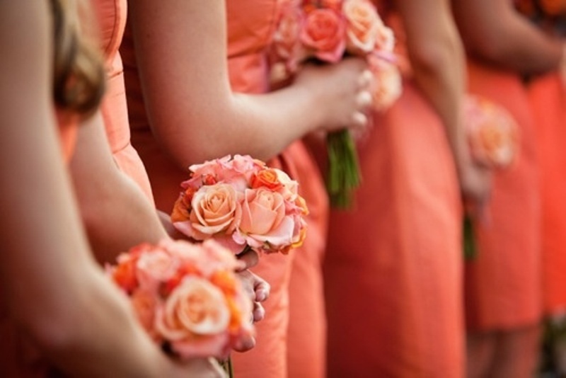 orange knee bridesmaid dresses paired up with orange and peachy pink bouquets are great for a bright summer or fall wedding