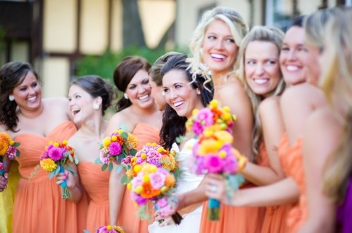 bright orange strapless bridesmaid dresses are great for a bold and colorful summer wedding