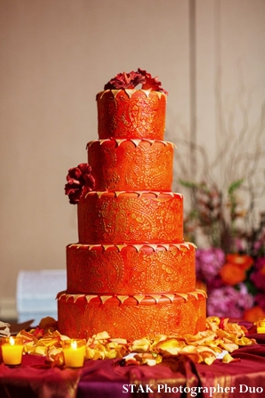 a textural orange wedding cake topped with burgundy blooms is a fantastic idea for a bright summer or fall wedding